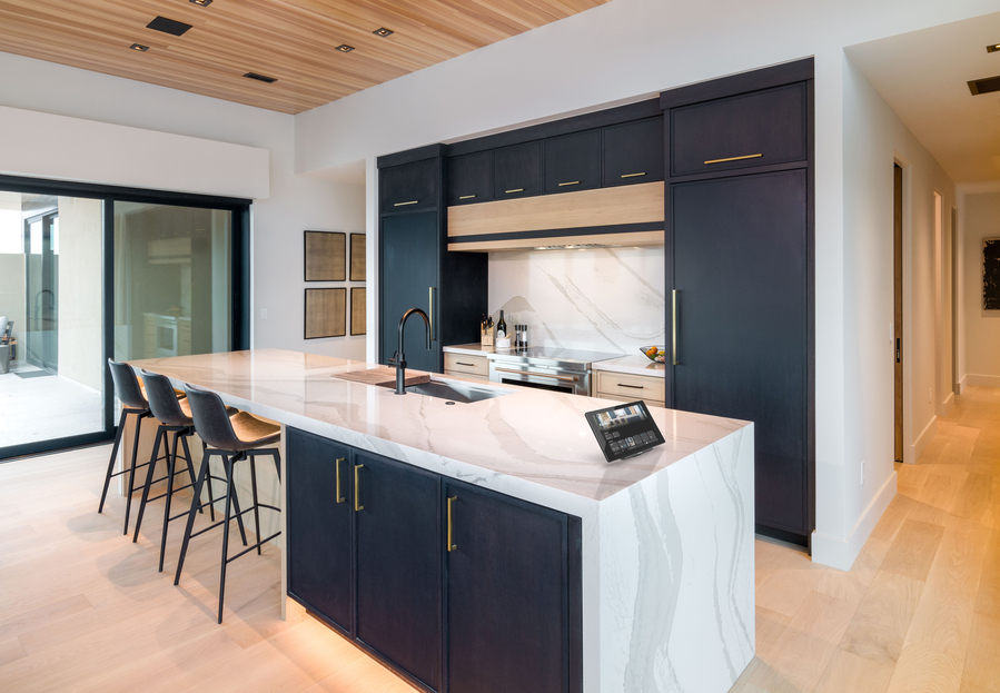 A modern kitchen with stylish under-cabinet lighting and warm illumination.