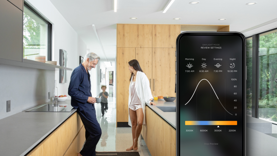 Family in a modern house, overlaid by a graphic of a smartphone with the Savant lighting interface.
