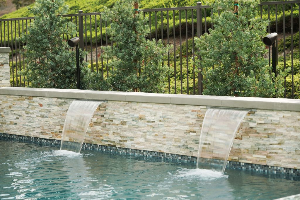 Pool with multiple speakers behind it