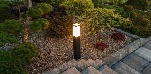 An outdoor lighting fixture illuminating a set of outdoor stairs.