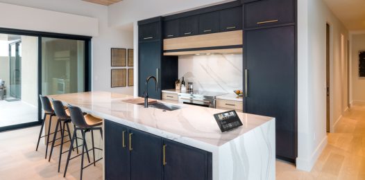 A modern kitchen with stylish under-cabinet lighting and warm illumination.