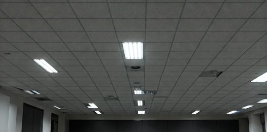 A drab office ceiling with fluorescent lights.