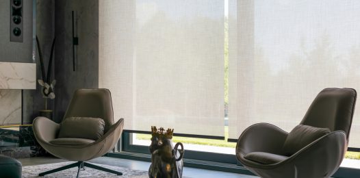 A living room with closed motorized blinds.