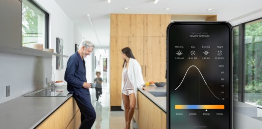 Family in a modern house, overlaid by a graphic of a smartphone with the Savant lighting interface.
