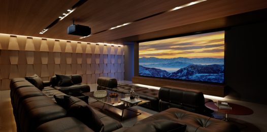 An elegant modern home theater in Collin County, TX, designed with a projector, large screen, and tiered seating.