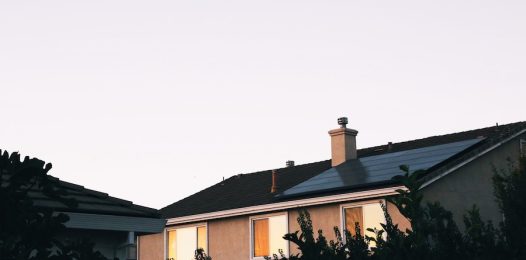A house with solar panels on the roof in the evening.